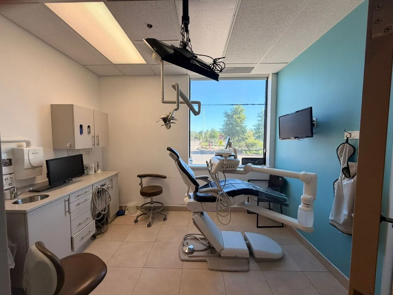 Dental treatment suite with chair, cabinetry and window